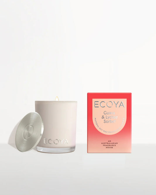 A scented candle with lid beside its packaging box marked "ECOYA Guava & Lychee Sorbet".