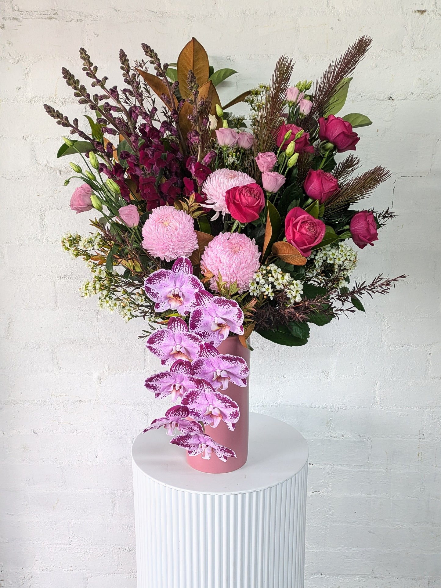 Elegant vase filled with a stunning arrangement of pink and purple flowers, creating a visually appealing centerpiece.
