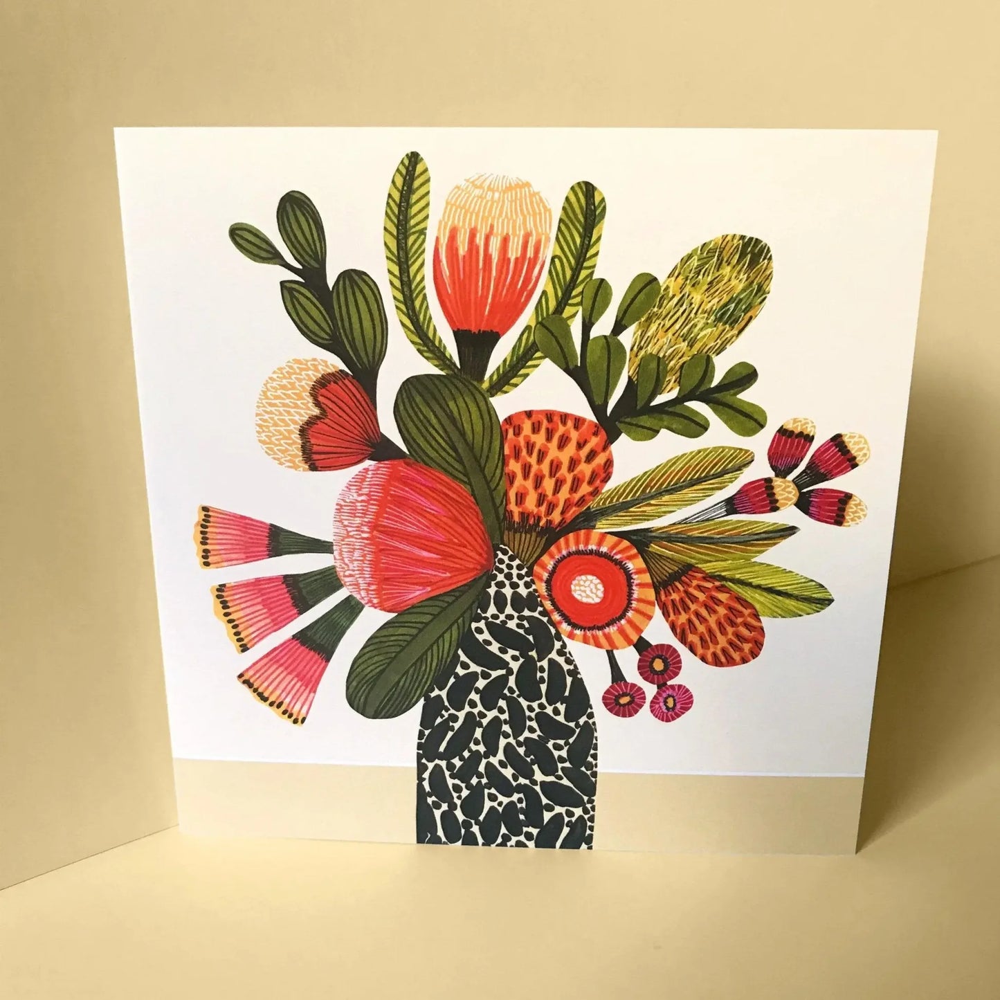 Greeting card with a colorful printed bouquet on a beige background.