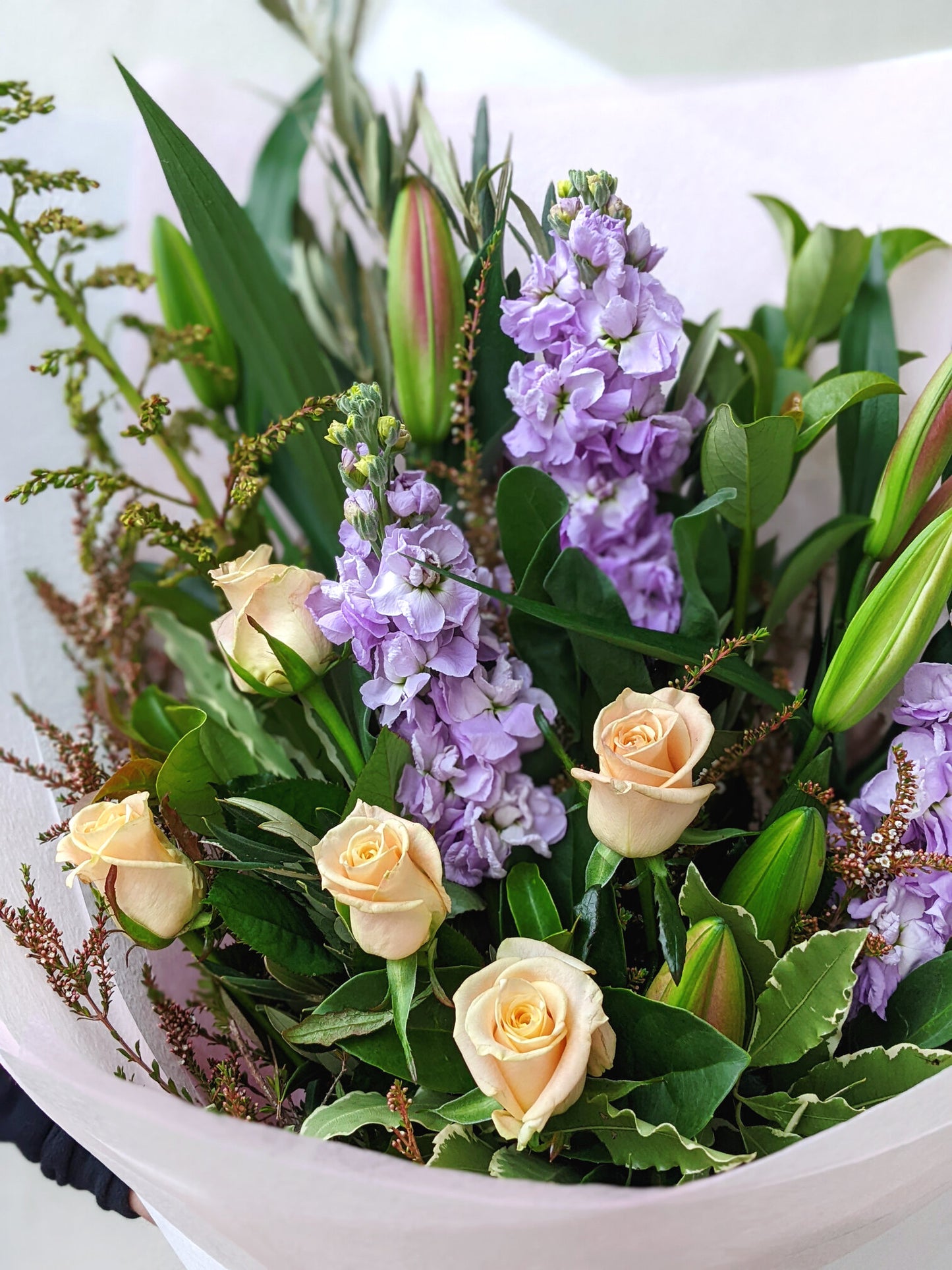 Stunning bouquet composed of purple and white flowers, elegantly arranged to highlight their delicate colors and forms.